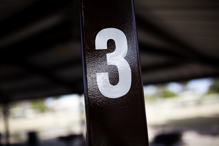 The number three on a post