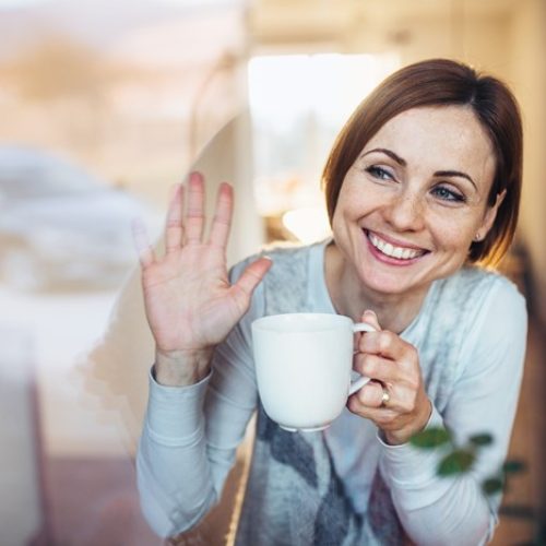 Young business owner waving goodbye after selling her business