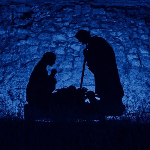 Christmas man nativity scene installation on theme of birth of Jesus Christ, shadow and silhouette.