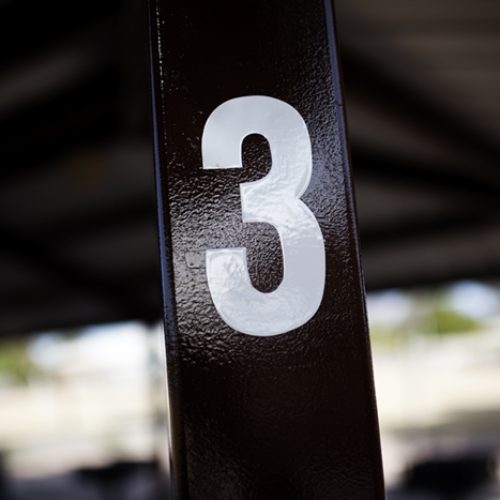 The number three on a post